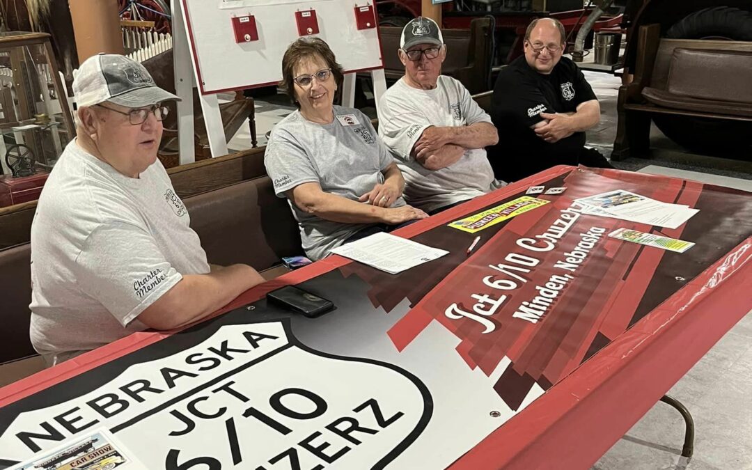 Group of JCT 6/10 Cruzerz members sitting at a booth at Pioneer Village.