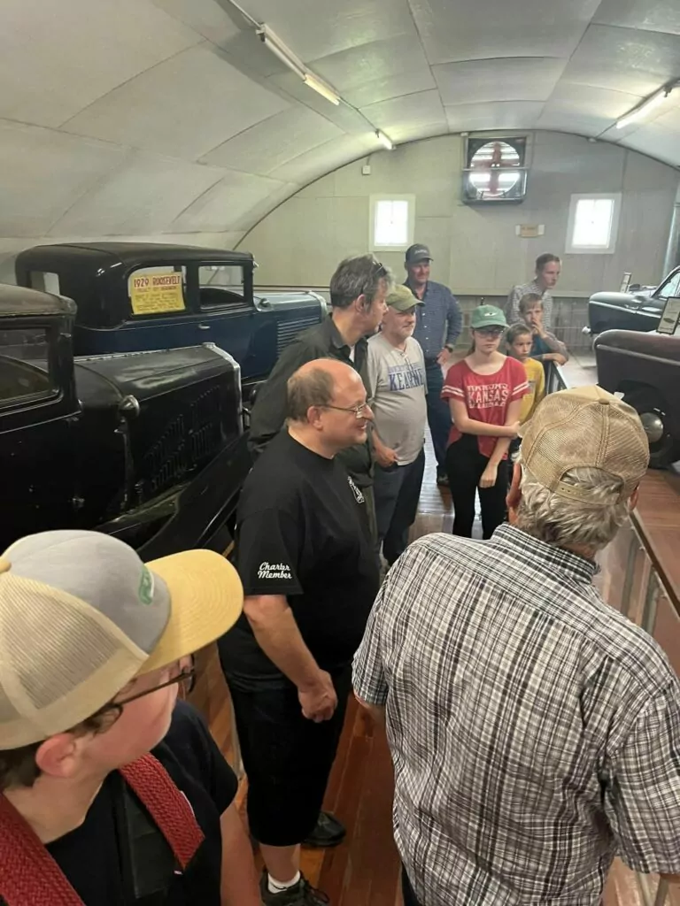 Members of the JCT 6/10 Cruzerz Car Club looking at the car collection in Pioneer Village.